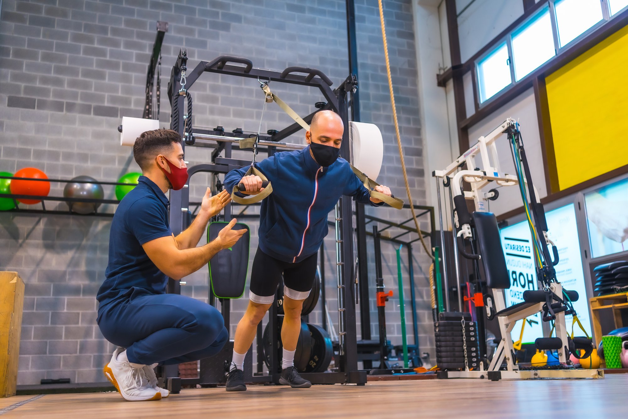 young-athlete-with-an-instructor-in-gym-doing-exer-2025-02-09-07-14-58-utc